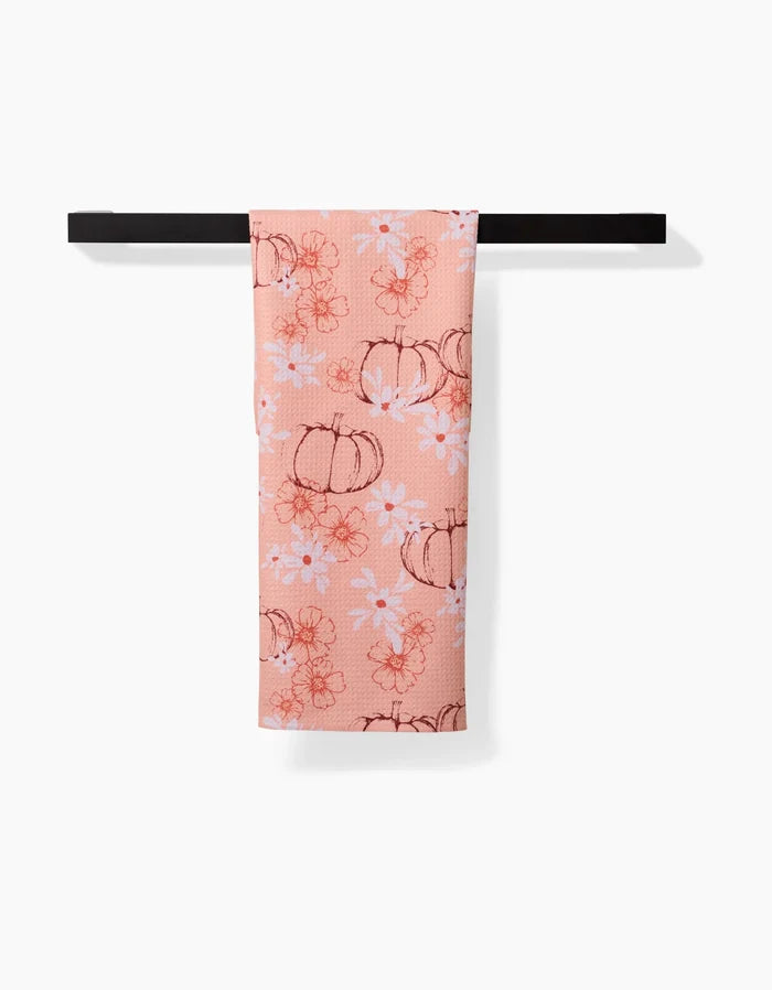 The Ashley Celena Sweet Pumpkin Harvest tea towel hangs neatly on a bar.