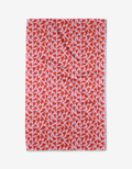 The Swooning Hearts tea towel by Kayla Ann features red abstract heart shapes on pink, is rectangular, quick-drying, made from recycled materials, and shown on a white background.