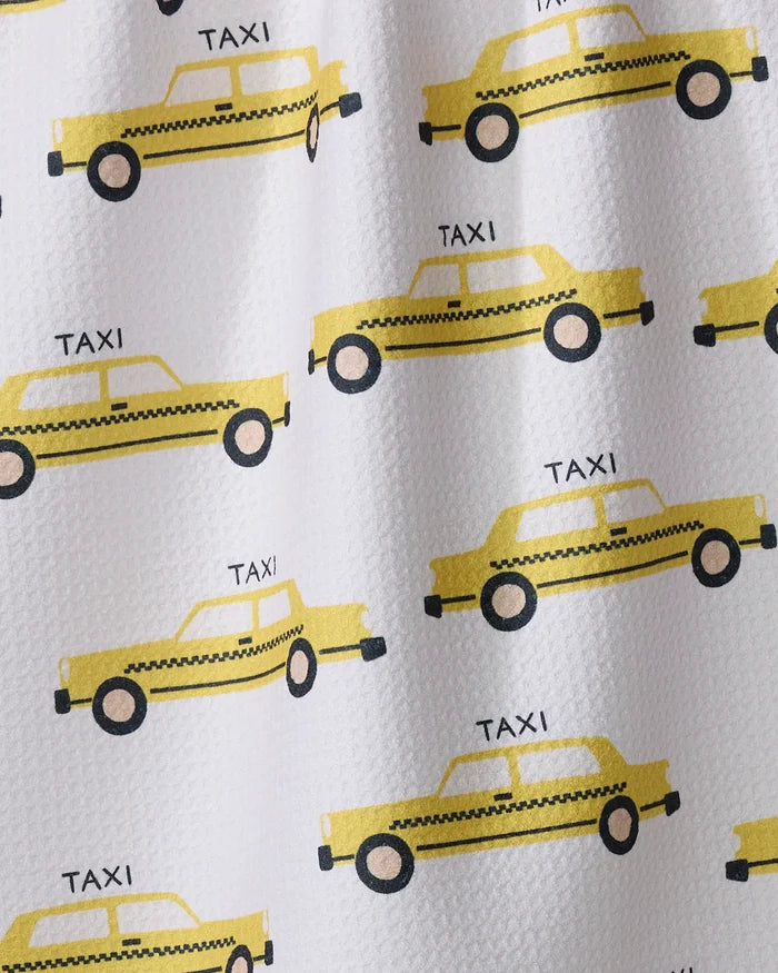 The Taxi Cabs tea towel by Vaishali Design Studio features a simple, cartoon-style pattern of yellow taxi cabs with "TAXI" above each car on a white background.