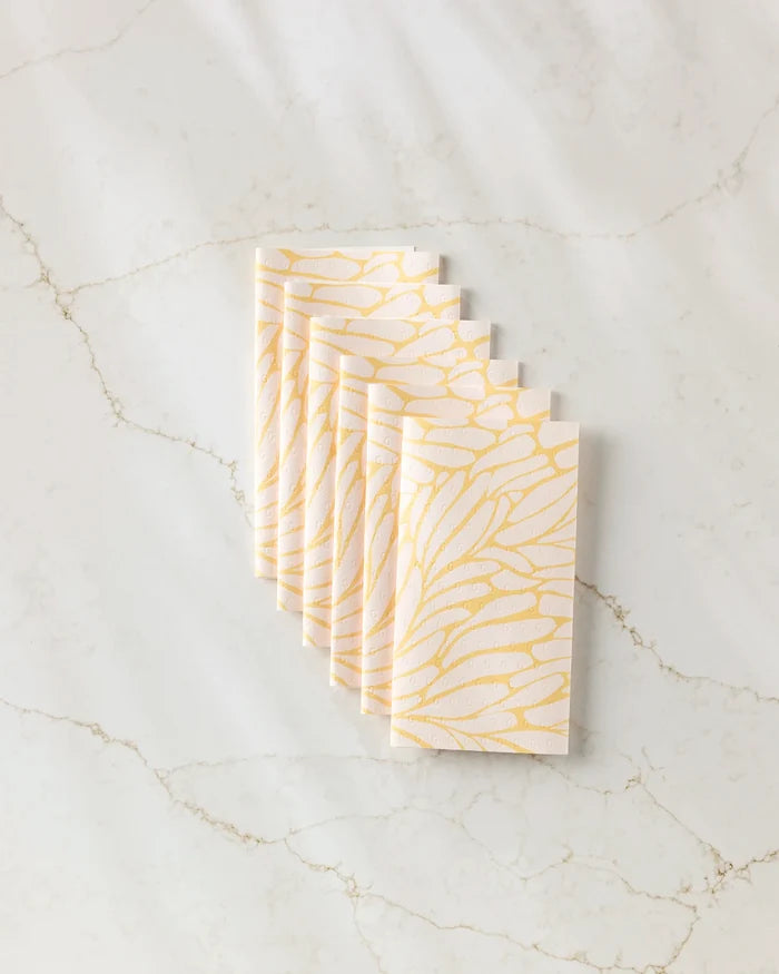 Seven "Tenderhearted" cards by GEOMETRY, featuring a yellow and white abstract feather pattern, are fanned out on a subtly veined light marble surface.