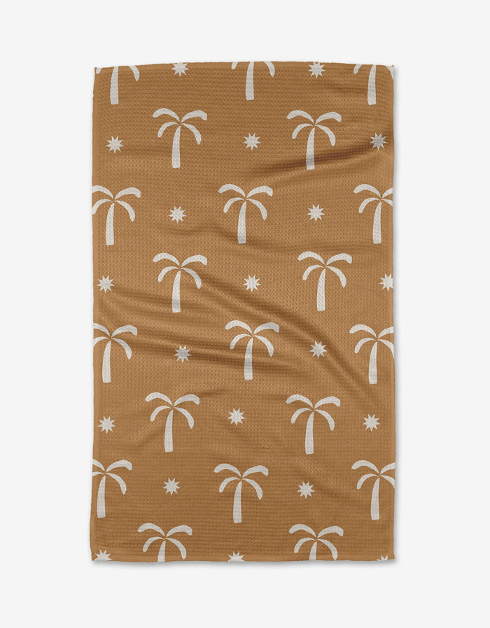 The Perfect Palm by Elizabeth Edwards is a brown tea towel with a white palm tree and star pattern, made from soft Geoweave fabric for extra absorbency.