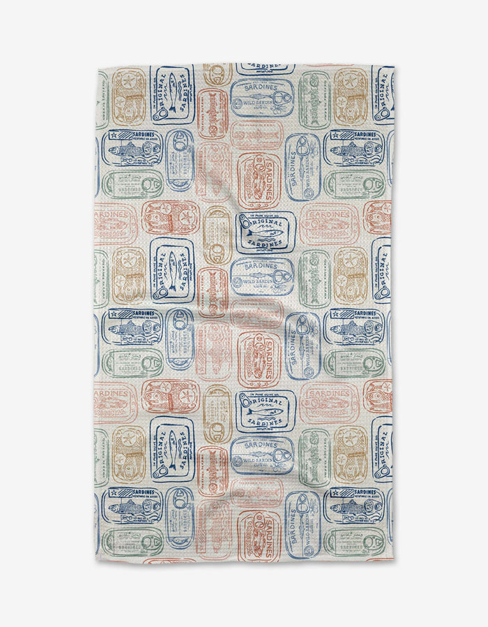 The Tinned Sardines Tea Towel by Hufton Studio features a colorful pattern of sardine cans in blue, red, and green on white Geoweave fabric, offering exceptional absorbency and durability.