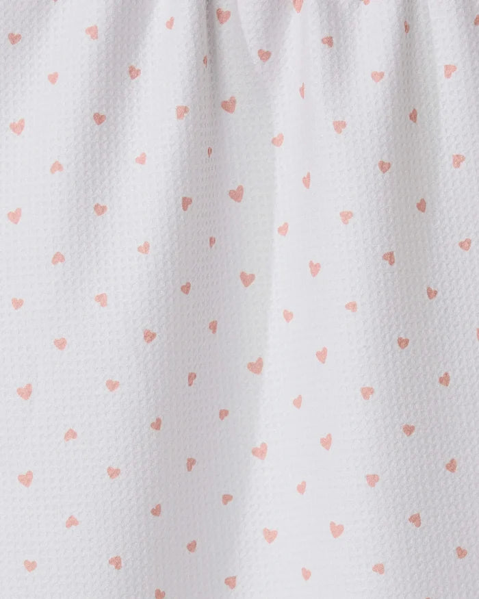 The GEOMETRY Tiny Hearts tea towel features ultra-absorbent white fabric with small pink heart patterns and a gathered top for soft folds and shadows.
