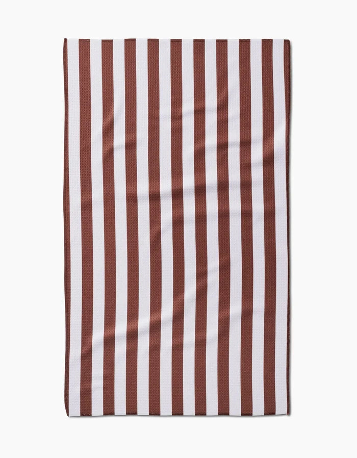 The Kailee Wright Toni Stripe Geoweave™ tea towel features vertical dark red and white stripes and a slightly wrinkled texture, shown laid flat on a white background.