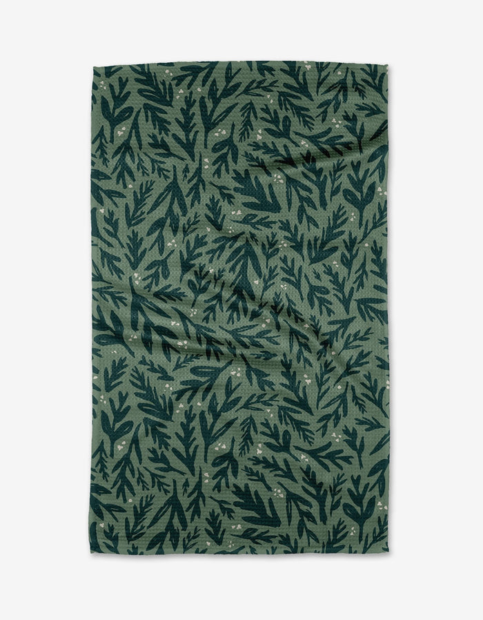 The Twig + Spark Trail Dusting green tea towel, crafted from eco-friendly Geoweave™ fabric, features a dark green leafy pattern with small pale dots and is displayed flat on a white background.
