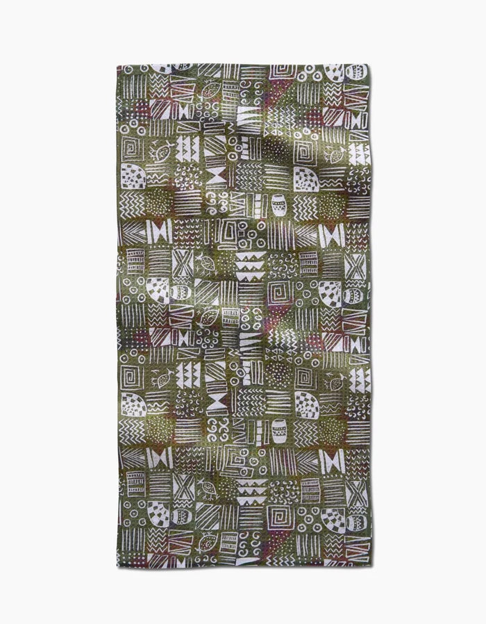 The Tribal Symbols bar towel by Taryn Brennan features eco-friendly Geoweave fabric with a green background and hand-drawn white, brown, and red geometric patterns arranged in a bold grid.
