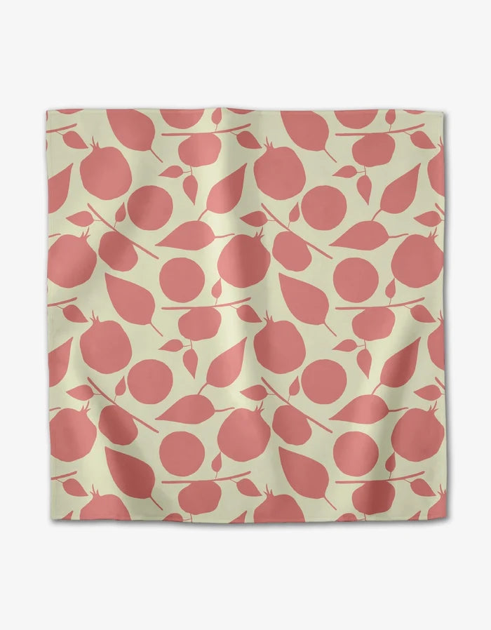 The Tropical Fruit dinner napkin set by Lizzie Clark features pink abstract pomegranates and leaves on light beige Geosuede fabric with natural creases from recycled materials.