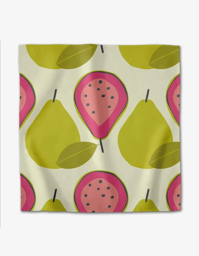 The Lizzie Clark Tropical Fruit napkin set features a square, recycled cloth with an off-white background and a repeating pattern of whole yellow-green pears and halved pink guavas with black seeds.