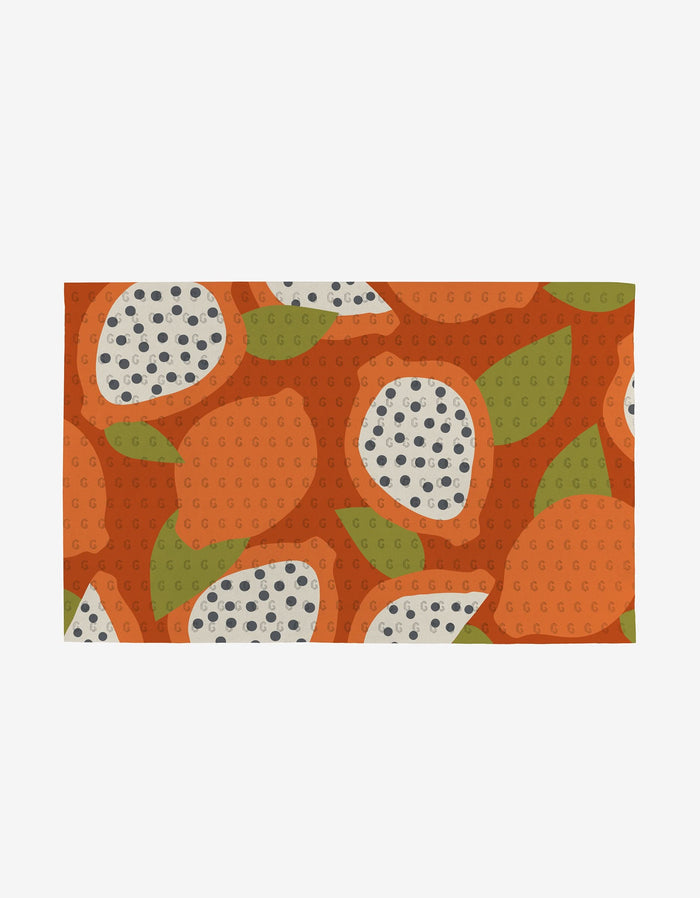 The Tropical Fruit rectangular mat by Lizzie Clark showcases orange, green, and white abstract fruit slices on an orange background—crafted from eco-friendly post-consumer recycled materials.