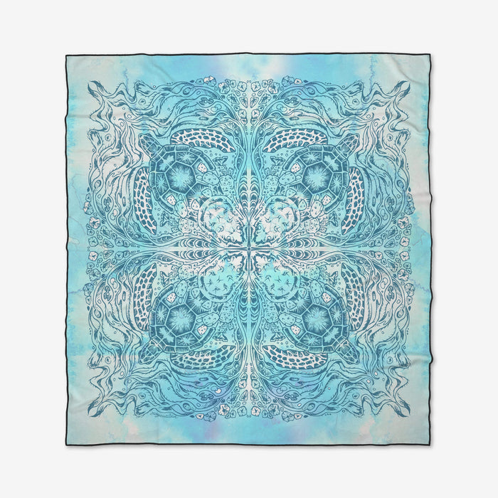 The Turtle square scarf by Skye Walker is made from recycled materials and features an intricate blue and turquoise mandala-inspired pattern with swirling lines, floral motifs, and abstract designs on a light background.