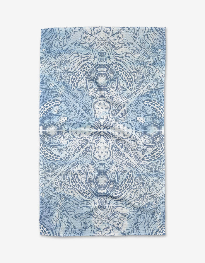 A blue and white Skye Walker Turtle Tea Towel with a symmetrical, intricate pattern of swirling lines and nature-inspired designs. Crafted from soft Geoweave™ fabric for lasting quality.