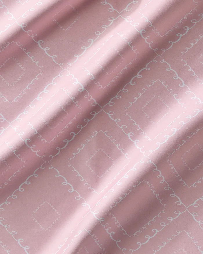 Elena Fay’s Twirls napkins feature soft pink eco-friendly fabric with a diamond pattern and delicate white curves. Gentle folds add shadows and highlights, making this Dinner Napkin Set perfect for stylish dining.