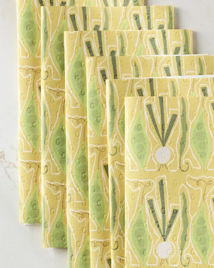 Six "Veg on Parade" reusable paper towels by Lizzie Clark are fanned out on a light surface, showcasing their eco-friendly abstract leafy and geometric patterns in green, white, and light yellow.
