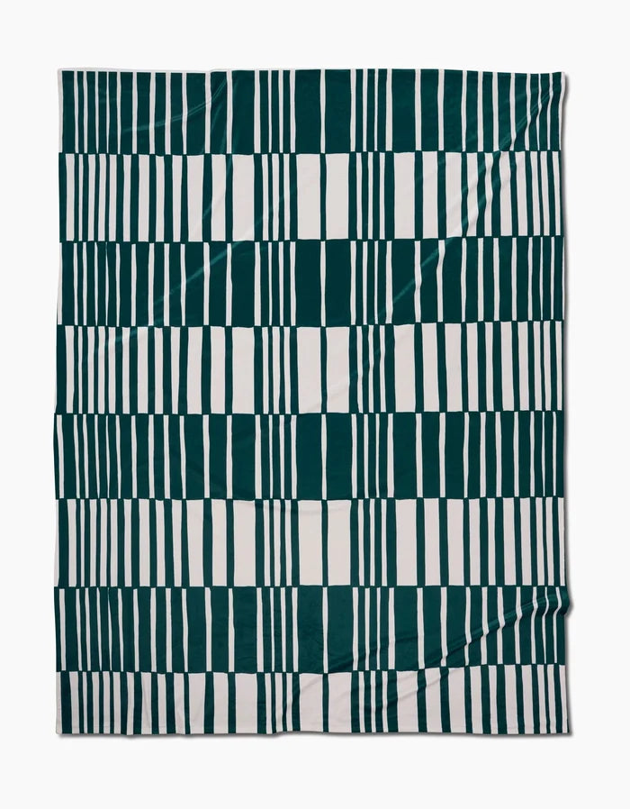 The Verdelia by Geometry is a rectangular textile featuring dark green and white stripes in a geometric grid design on a flat, slightly wrinkled surface, crafted from recycled materials for sustainability.