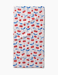 The Kayla Ann Very Cherry Bar Towel is rectangular and white, featuring red cherries with blue stems and leaves on Geoweave fabric for extra absorbency and durability.
