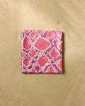 The Elisabeth Wing Vibrant Venom is a folded fabric featuring a pink and purple abstract dotted pattern, set on a textured beige background, perfect as a stylish quick-drying beach blanket.