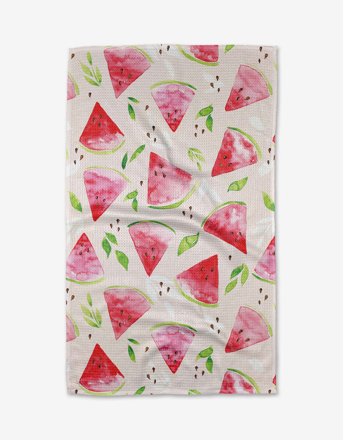 The Elena Fay Watermelon Slice Tea Towel is white with a watercolor watermelon and green leaf pattern, made from recycled materials for an eco-friendly touch.