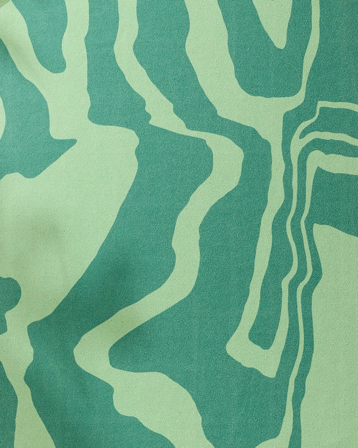 The GEOMETRY Watermelon Vibes recycled yoga towel features an abstract pattern of wavy green and teal lines, evoking a topographic map or zebra stripes.