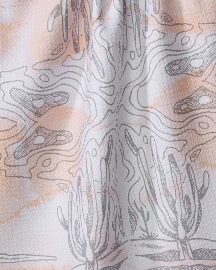 A close-up of Skye Walker’s Waves fabric, made from recycled materials with an abstract desert pattern of hand-drawn cacti and wavy lines in soft earth tones—ideal as a stylish kitchen towel or tea towel.