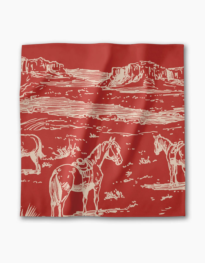 The Geometry Western Scene bandana features a red background with a cream line drawing of three saddled horses in a desert landscape with mesas—great to pair with eco-friendly or recycled dinner napkins.
