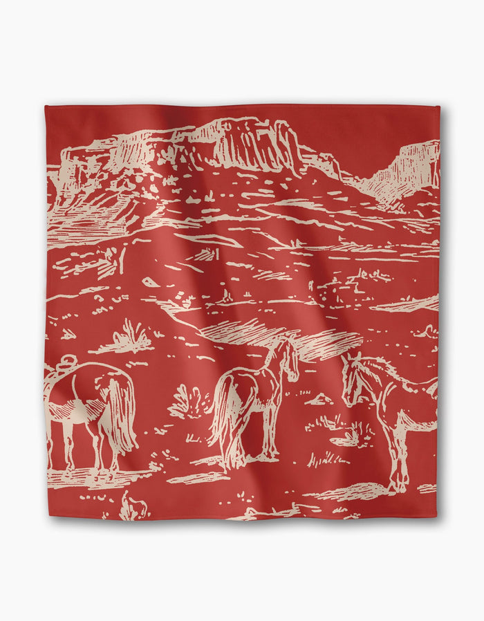 The Western Scene bandana by Geometry features a cream illustration of two horses in a desert landscape, making it a stylish, eco-friendly accent for your recycled dinner napkins collection or table setting.