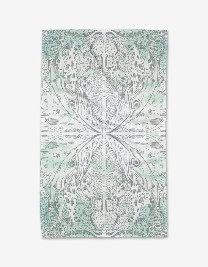 The Whale kitchen tea towel by Skye Walker showcases an abstract design in soft green and gray, with symmetrical, organic patterns and topographic lines on a rectangular towel crafted from recycled materials.