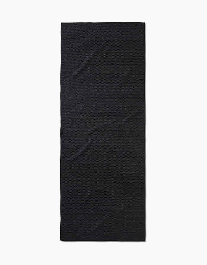 The When I Close My Eyes yoga towel by Stefanie Bales is rectangular, slip-resistant, and made of black fabric. It lies flat on a white background with subtle surface wrinkles.