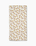 The Wildflower Vine Honey Bar Towel by Danelys Sidron features a white rectangular design with small yellow and brown flowers and green leaves, made from ultra-absorbent Geoweave fabric, shown on a plain white background.