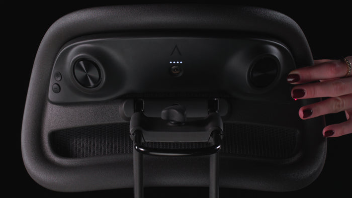 Rear close up powering on the Atlas Aeron Chair Headrest Bluetooth Speaker