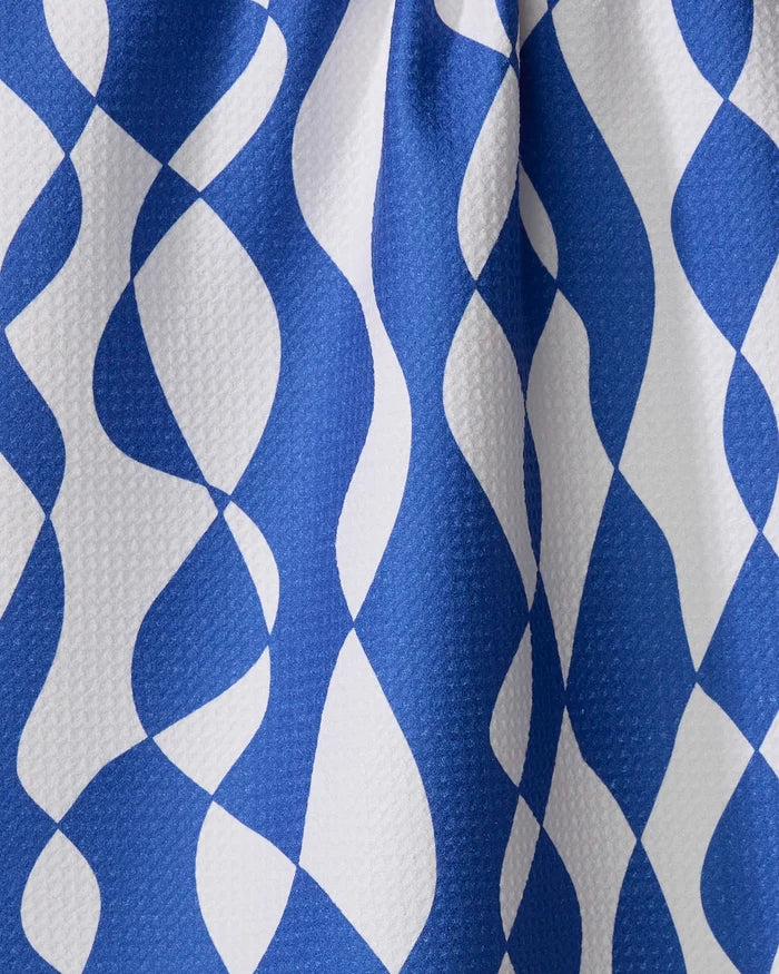The Wonky Lines towel by Claire Iglesias features blue and white fabric with a geometric, wavy diamond pattern. Its ultra-absorbent, textured design adds an abstract, optical effect—an ideal stylish touch for any kitchen.
