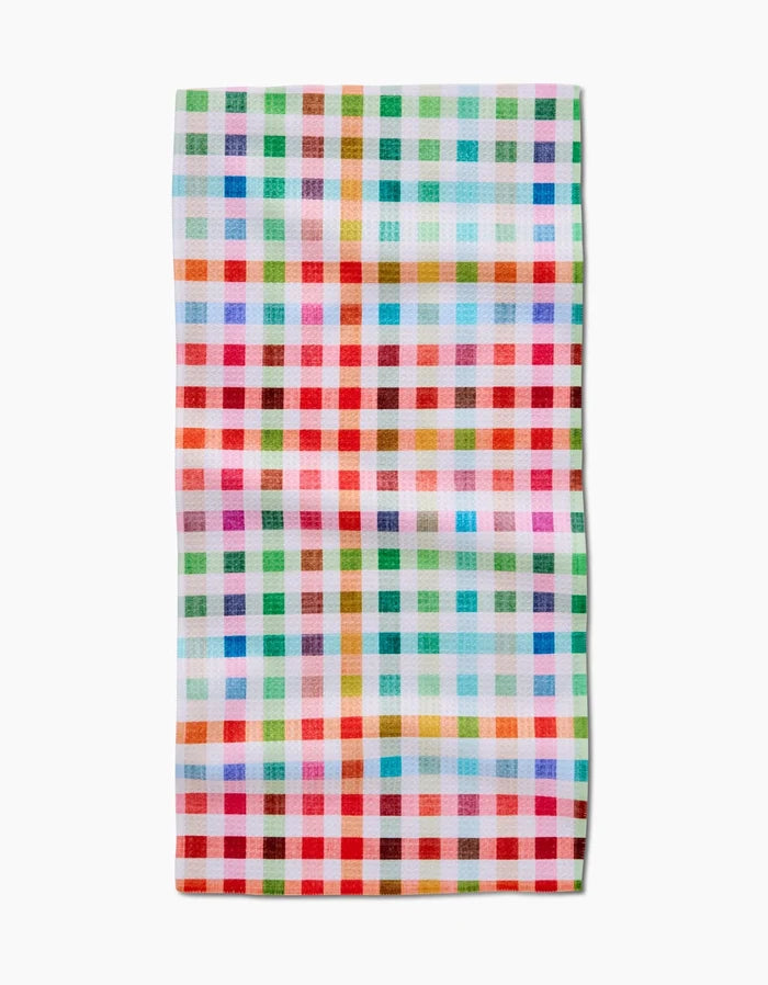 The Pascale Dilger Woven Spring Plaid Bar Towel, featuring red, green, blue, orange, pink, and white checks, is crafted from absorbent Geoweave fabric and laid flat against a white background.