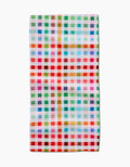 The Pascale Dilger Woven Spring Plaid Bar Towel, featuring red, green, blue, orange, pink, and white checks, is crafted from absorbent Geoweave fabric and laid flat against a white background.