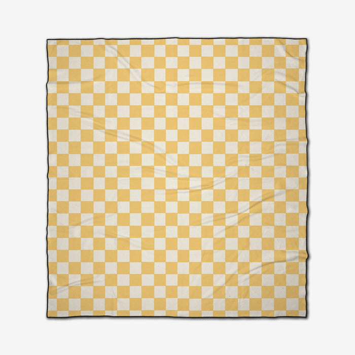 The GEOMETRY Yellow Checker is a rectangular micro-loop beach blanket featuring a yellow and white checkerboard pattern with a slim dark border. Made from recycled materials, it’s quick-drying for convenience and shown laid flat with slight wrinkles.