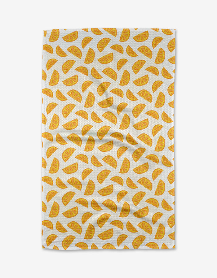 The Aubrey Fairchild Zesty Slice tea towel features a repeating pattern of yellow-orange citrus wedges on eco-friendly Geoweave fabric.