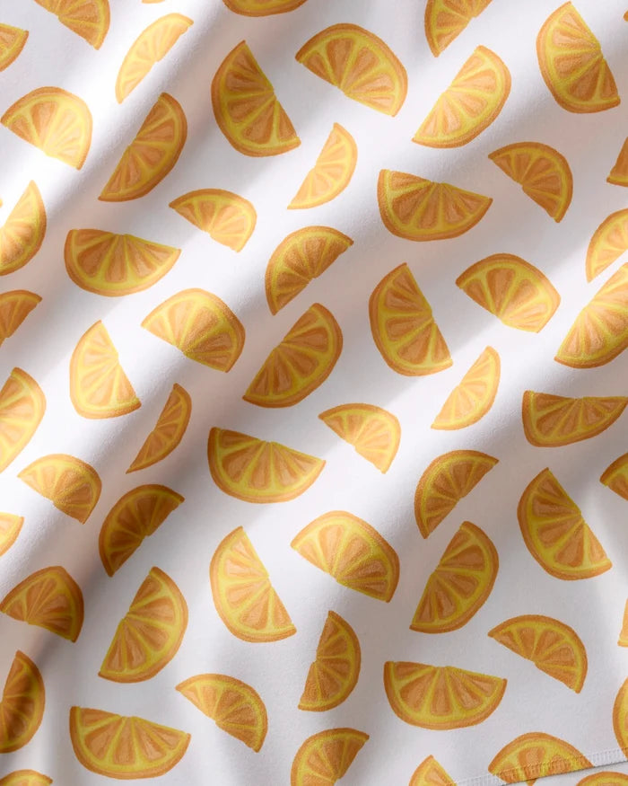 Brighten your table with Zesty Slice napkins by Aubrey Fairchild—featuring repeating yellow orange slices on white, soft shadows for texture, and highly absorbent fabric. Perfect for lively, stylish dining!.