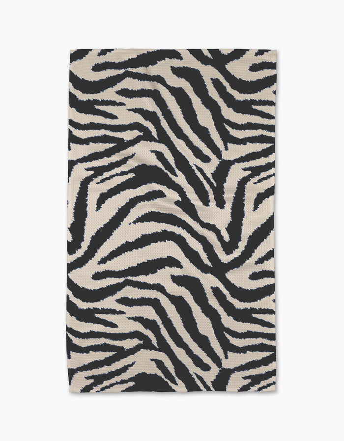 The Geometry Zira Black rug is a rectangular piece featuring bold black and white zebra stripes, crafted from recycled materials and displayed flat against a white background.